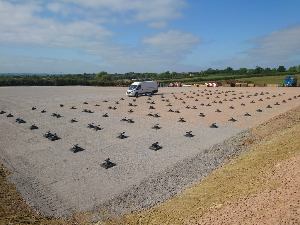van next to fouhndation pads ready for a build on a large construction site